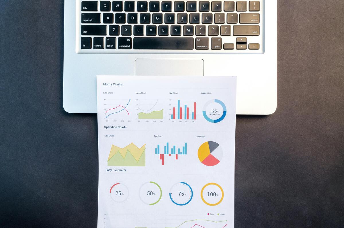 graphs on a sheet of paper by a laptop, Excel tips and tricks